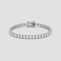 A silver tennis bracelet with a continuous row of round-cut clear stones and a clasp closure, shown on a light gray background.