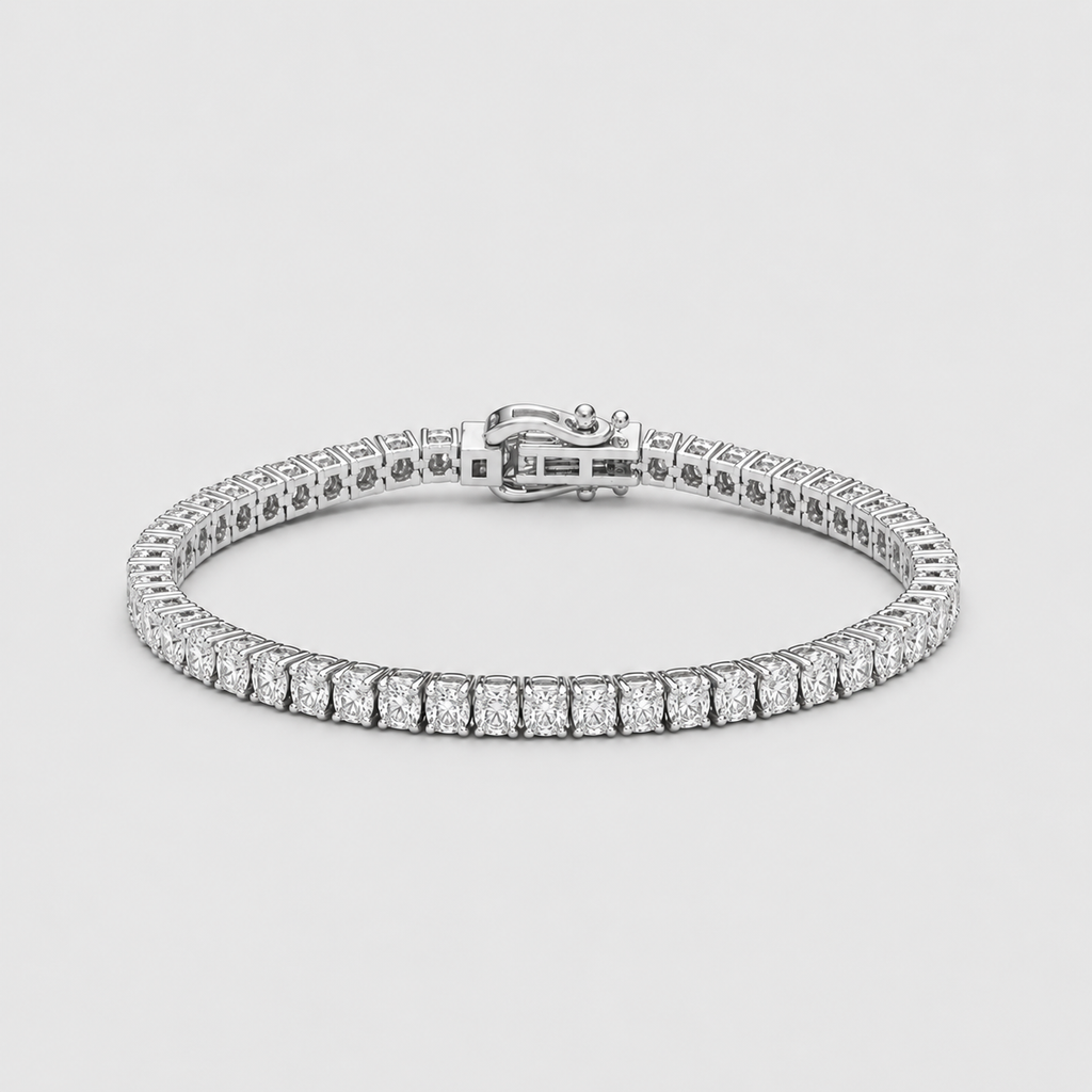 A silver tennis bracelet with a continuous row of round-cut clear stones and a secure clasp, shown on a light gray background.