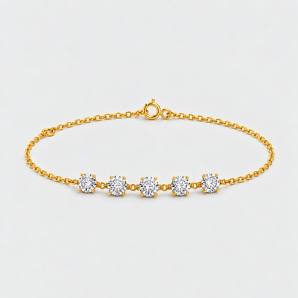 A delicate yellow gold chain bracelet with five round-cut clear gemstones set in prong settings, displayed on a clean light gray background.