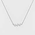 A silver chain necklace featuring a small zigzag pendant paved with clear stones, shown against a light gray background.