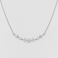 A delicate silver chain necklace featuring a curved bar of small, clear gemstone clusters set in silver, displayed against a light gray background.