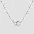 A silver chain necklace featuring a double interlocking ring pendant, with one ring detailed with small clear stones, set against a light gray background.