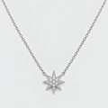 A silver-toned chain necklace featuring a multi-pointed starburst pendant paved with small clear stones, shown against a light gray background.