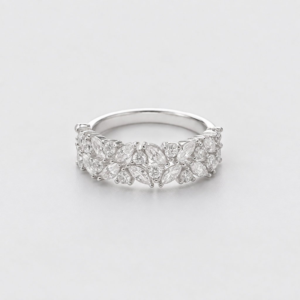 A silver band ring adorned with marquise-cut and round diamonds, photographed on a clean, light gray background.