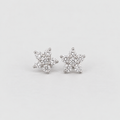 A pair of silver stud earrings shaped like snowflakes, set with small clear cubic zirconia stones, on a light gray background.