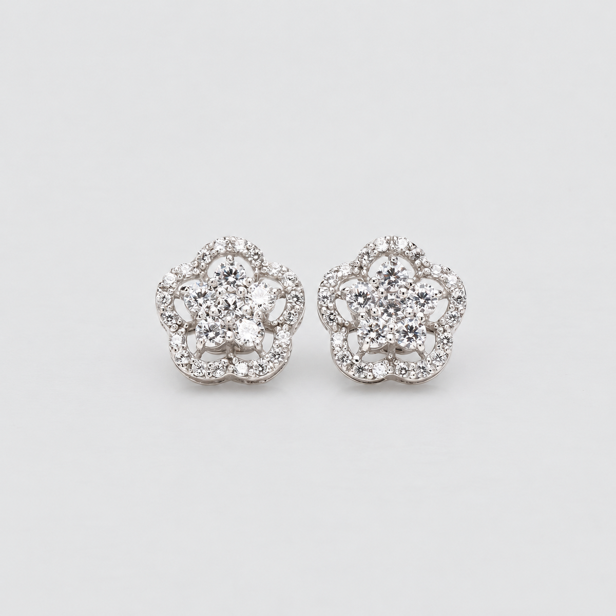 Floral diamond cluster stud earrings in white gold