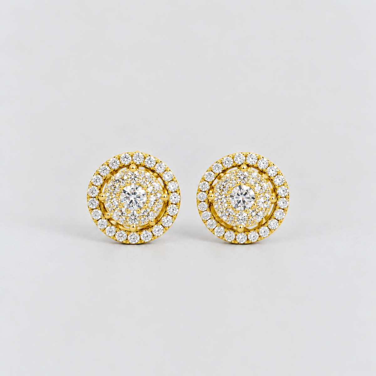 Round cluster diamond stud earrings in yellow gold with a halo border