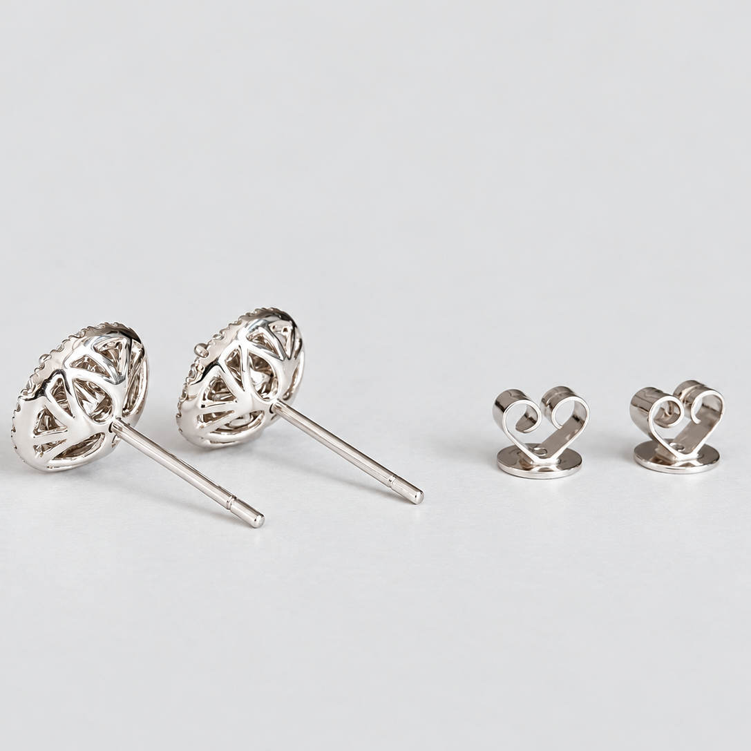 Side view of women's round cluster diamond stud earrings with ear nuts.
