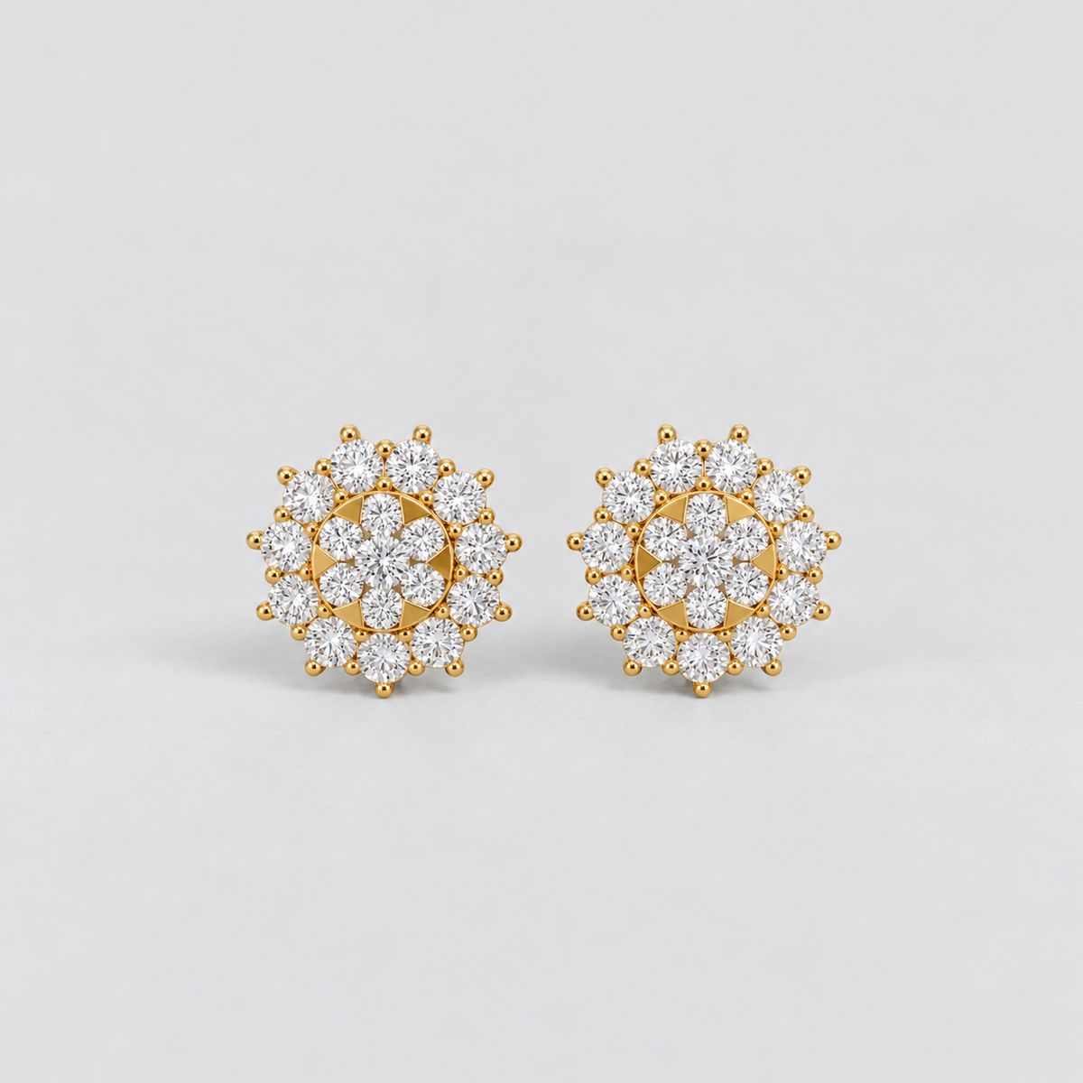 Elegant cluster diamond stud earrings for women, floral halo design with round cut diamonds in yellow gold.