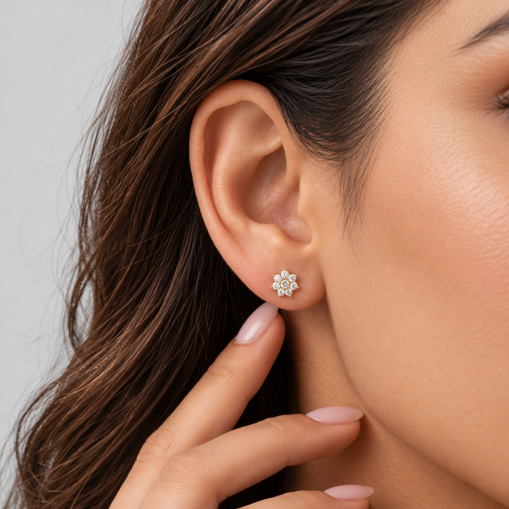 Close-up of a woman wearing a round diamond cluster stud earring.