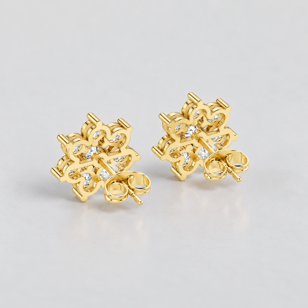 A pair of women's gold stud earrings featuring an intricate, snowflake-like cluster design set with small, round-cut diamonds.