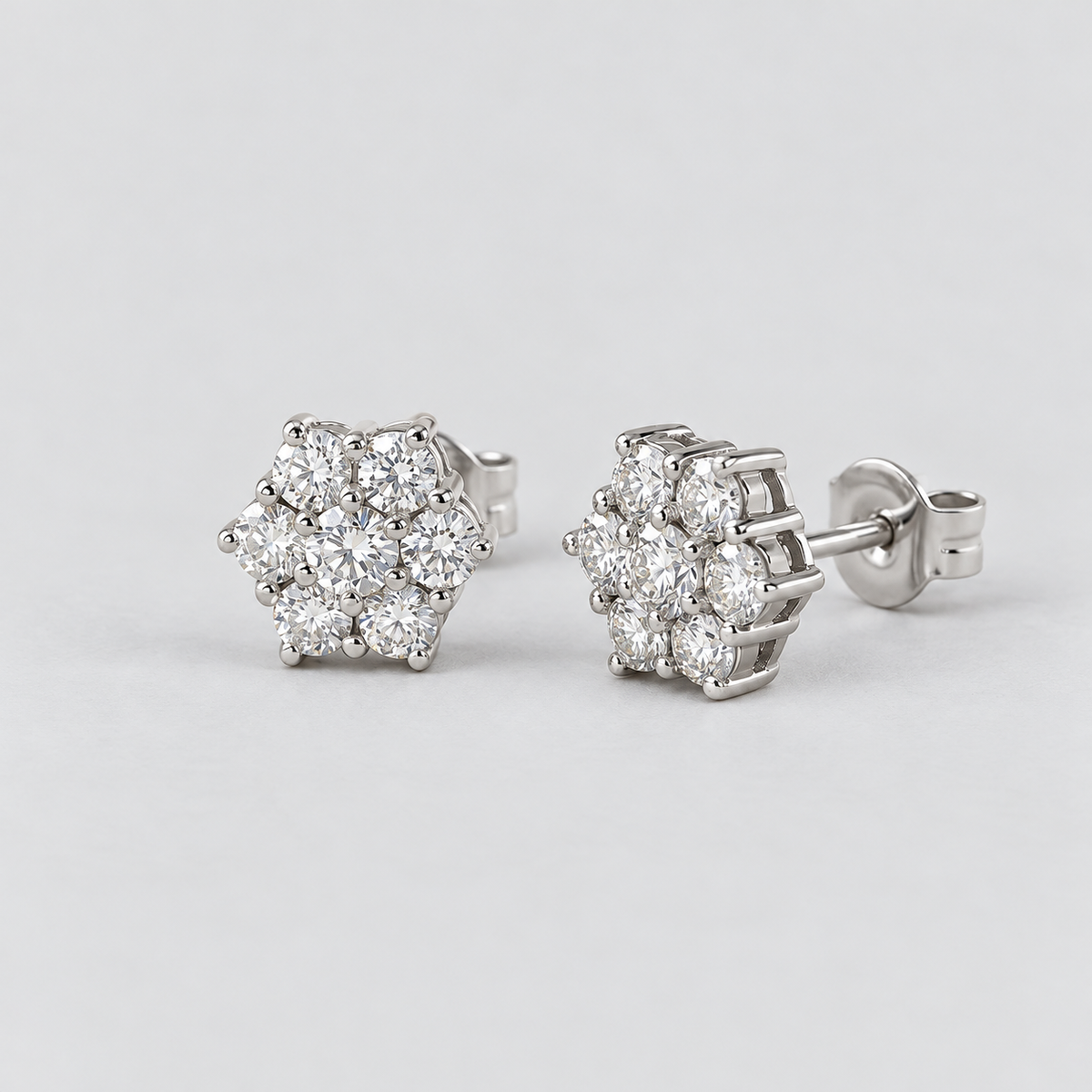 Pair of women's round flower cluster lab-grown diamond stud earrings set in white gold.
