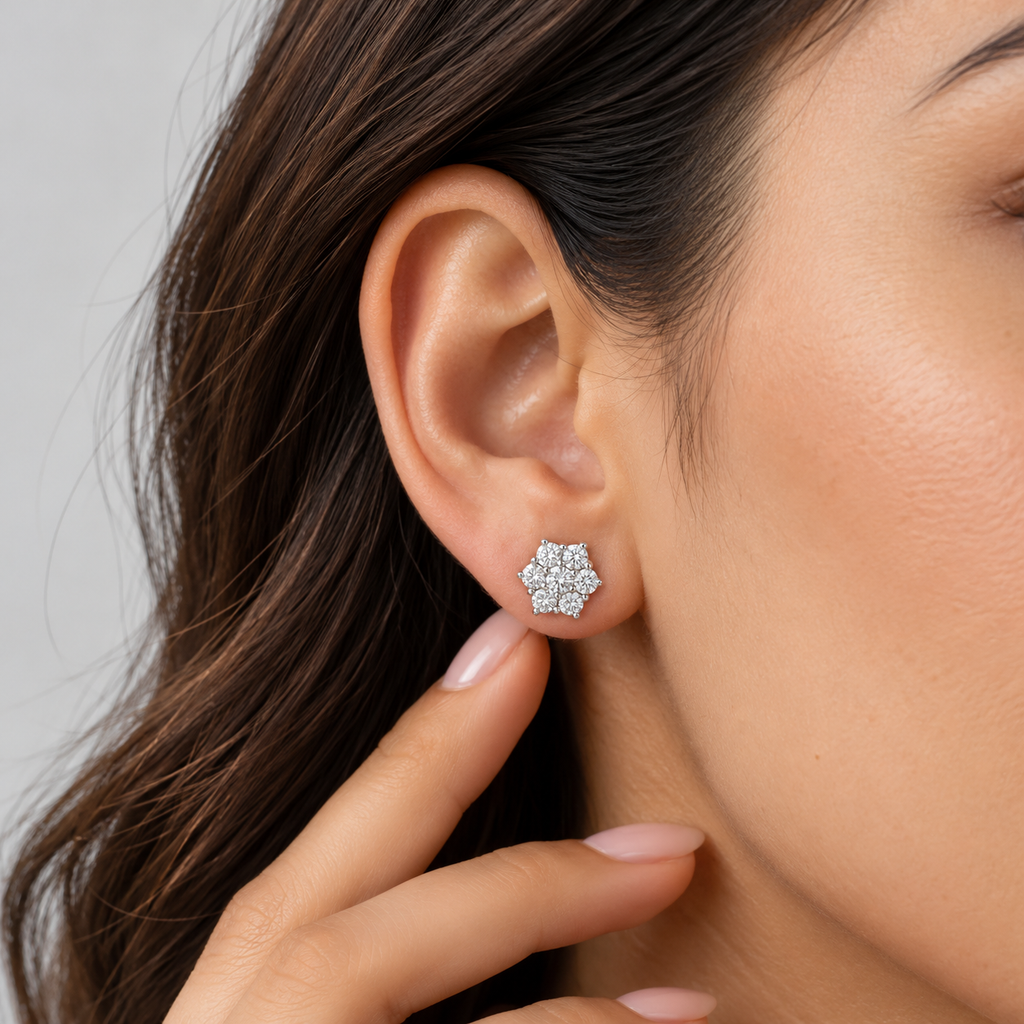 Close-up view of a woman wearing a cluster diamond flower stud earring.