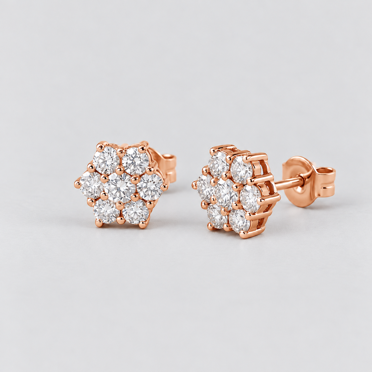 Pair of women's round flower cluster lab-grown diamond stud earrings set in rose gold.