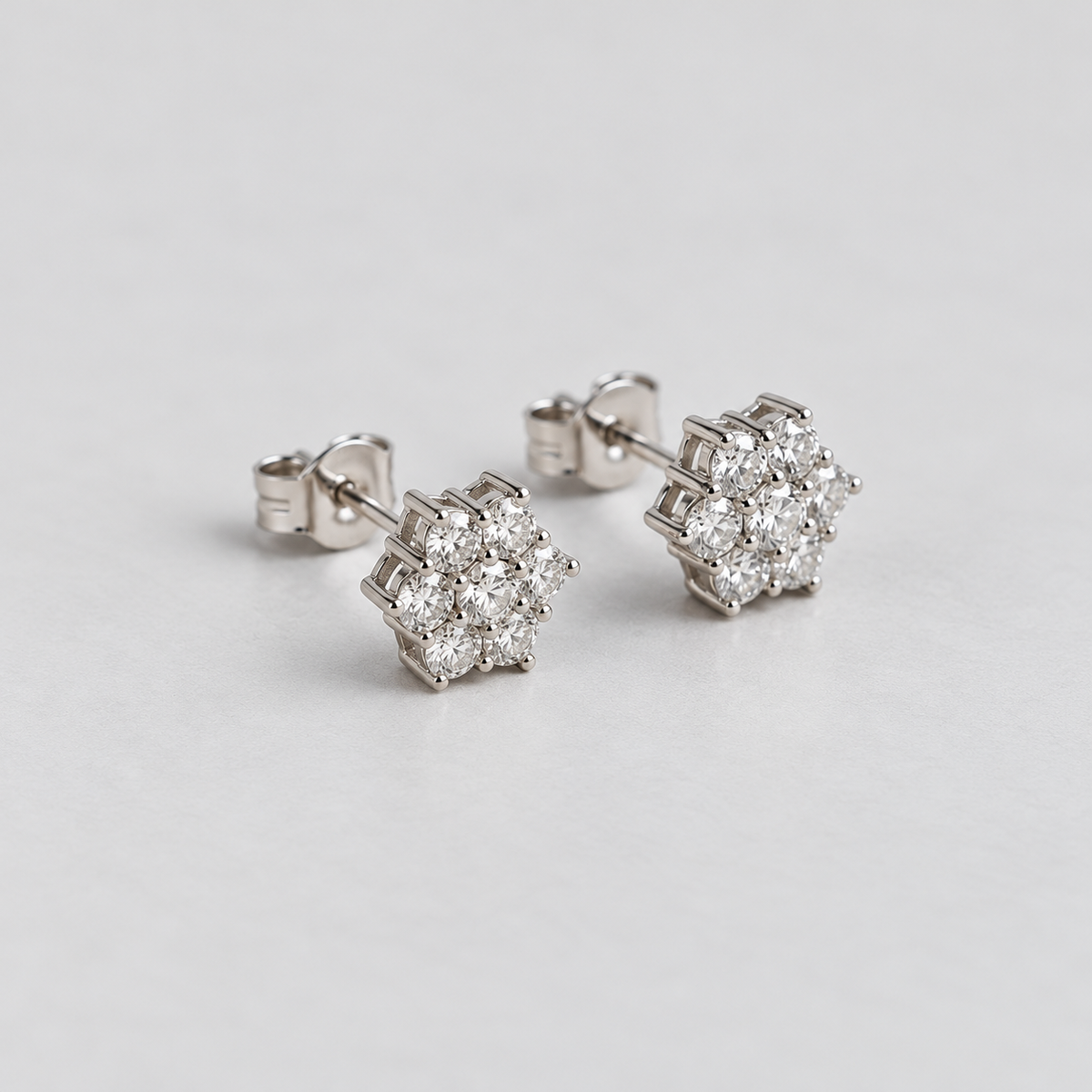 Close-up shot of elegant white gold cluster diamond stud earrings for women.
