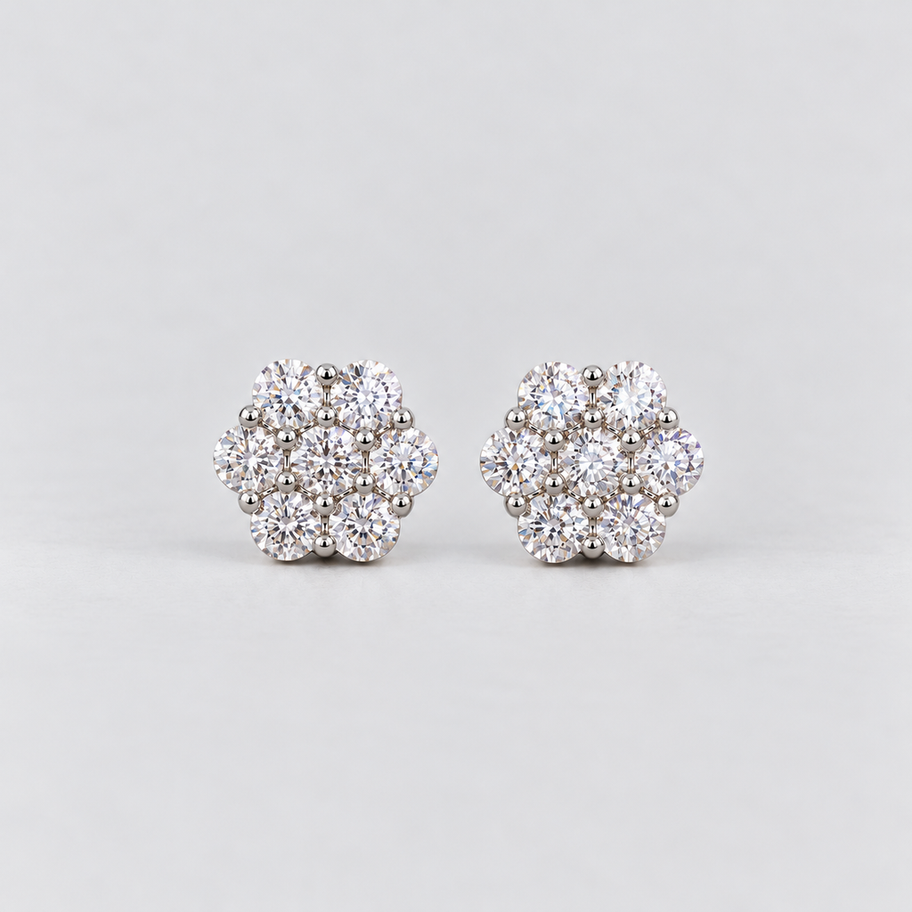 A pair of women's diamond cluster stud earrings in a hexagonal floral pattern in white gold metal.