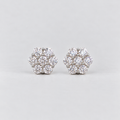 A pair of women's diamond cluster stud earrings in a hexagonal floral pattern in white gold metal.