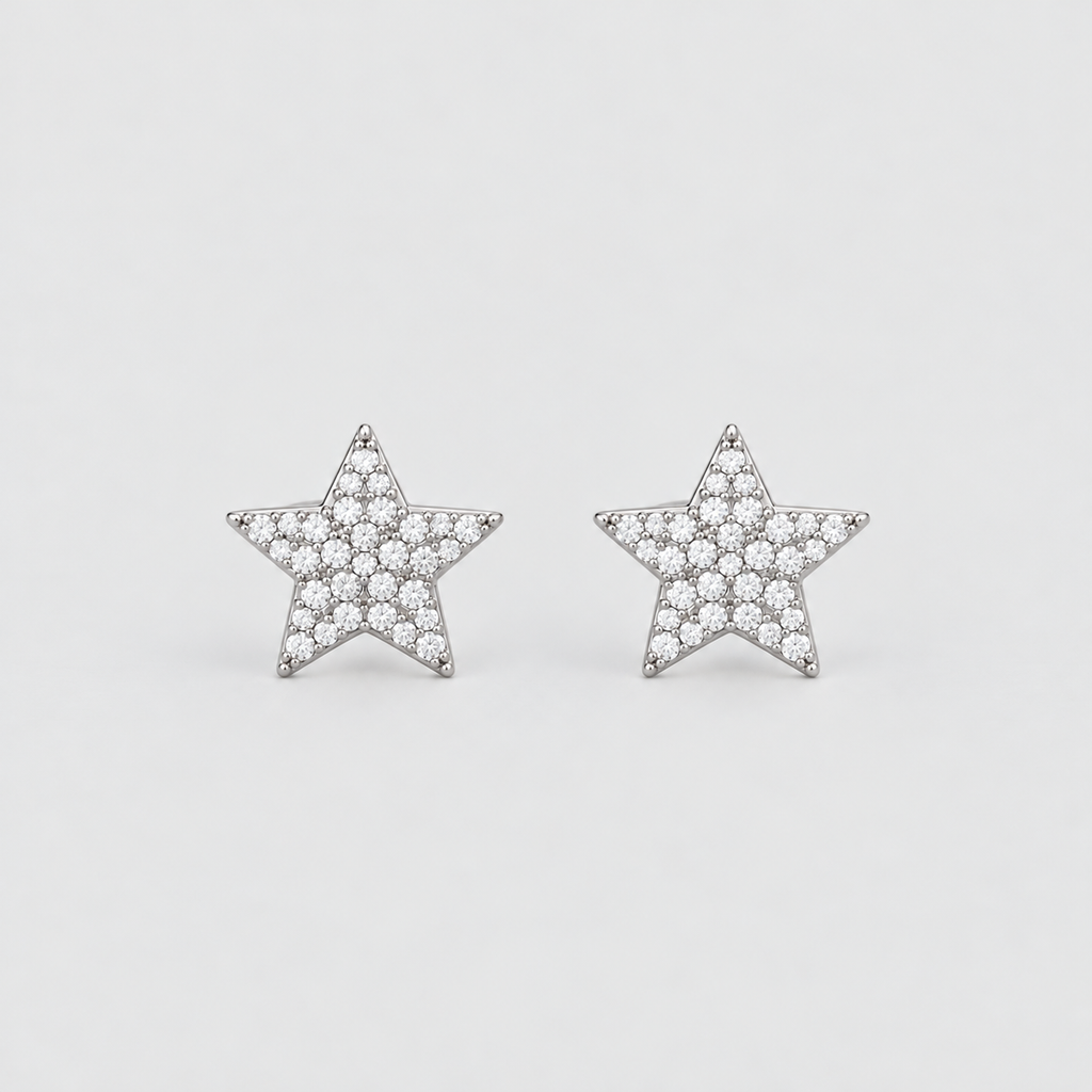A pair of star-shaped stud earrings paved with small clear stones in a silver-tone setting, displayed on a clean light gray background.