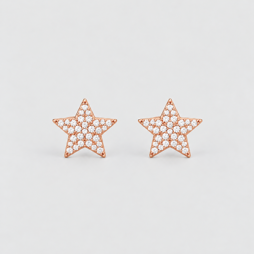 A pair of rose gold star-shaped stud earrings paved with small clear gemstones, set against a clean light gray background.