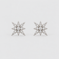 A pair of star-shaped stud earrings set with clear gemstones in a silver-toned metal, displayed on a clean, light gray background.