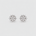 A pair of silver-toned flower-shaped stud earrings set with clear gemstones, displayed on a clean, light gray background.