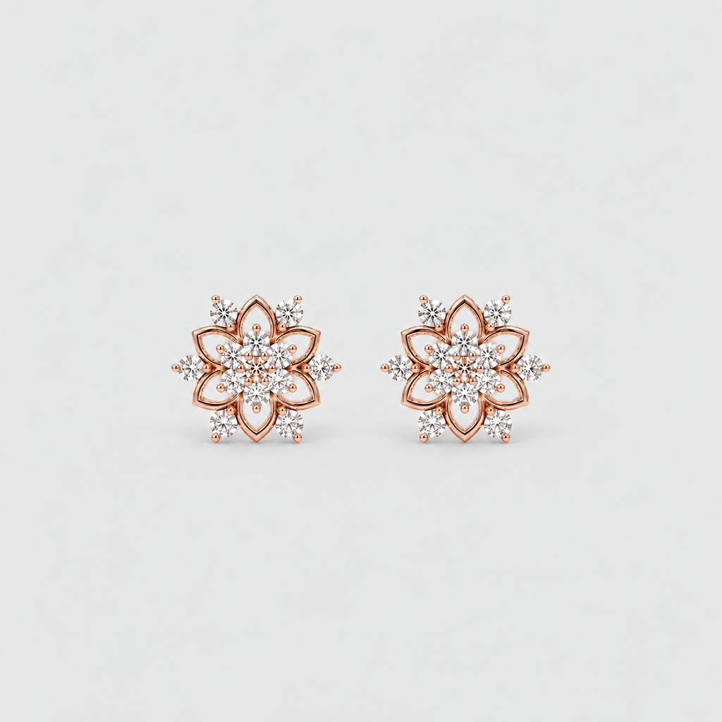 A pair of rose gold stud earrings with a floral mandala design, featuring clear pavé-set gemstones, shown on a light gray background.