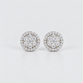 A pair of round diamond stud earrings with a double halo setting in silver-toned metal, photographed on a clean light gray background.