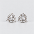 A pair of heart-shaped stud earrings in silver-tone metal, adorned with clear pavé diamonds and a central cluster of round diamonds, set against a plain light gray background.