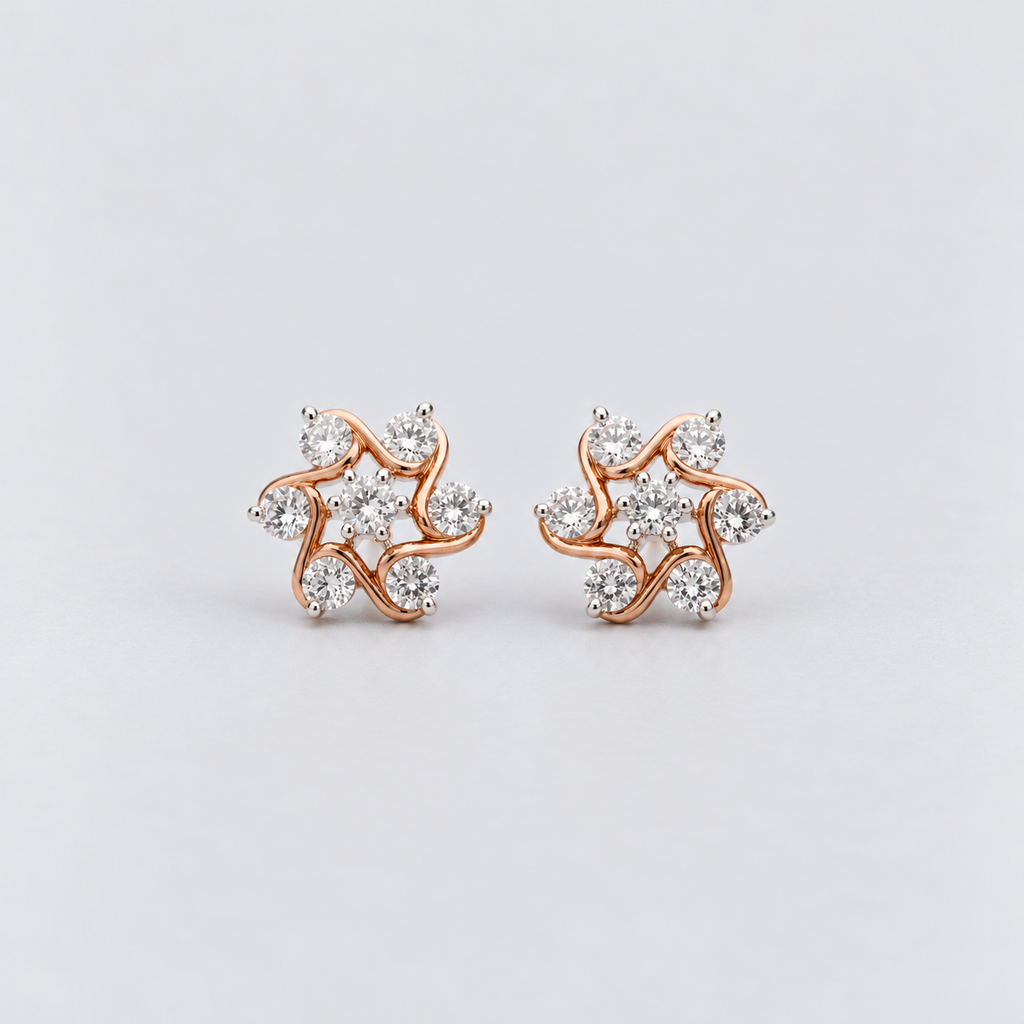 A pair of rose gold stud earrings with clear cubic zirconia stones, arranged in a swirling, abstract floral pattern on a light gray background.