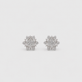 A pair of snowflake-shaped stud earrings made of silver-toned metal and clear stones, displayed on a light gray background.