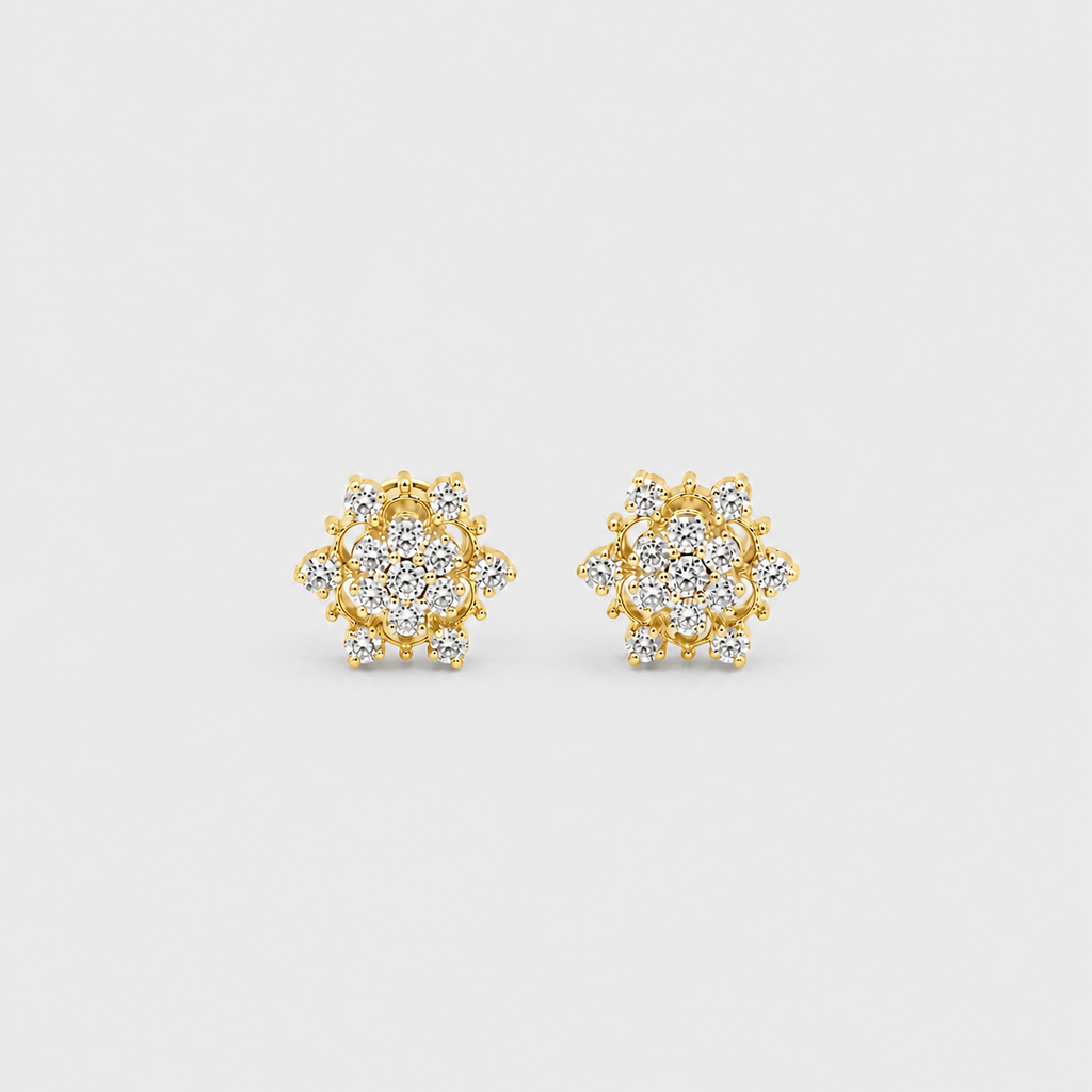 A pair of gold stud earrings with round cluster pavé settings set with clear stones, displayed on a light gray background.