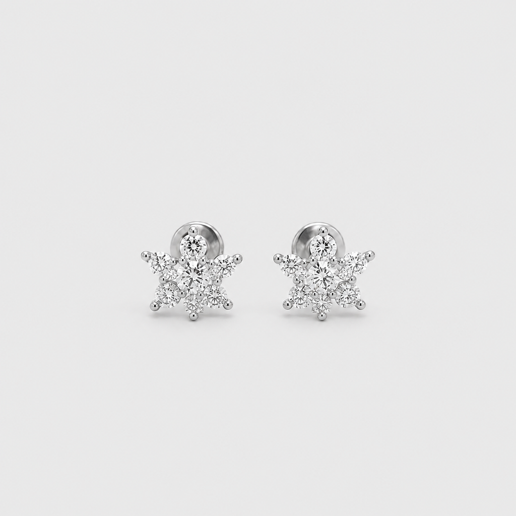 A pair of silver snowflake stud earrings set with clear cubic zirconia stones, displayed on a light gray background.
