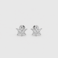 A pair of silver snowflake stud earrings set with clear cubic zirconia stones, displayed on a light gray background.