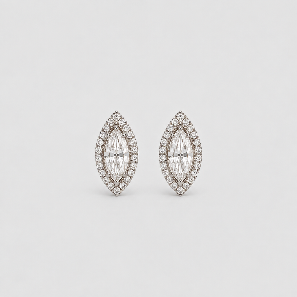 A pair of marquise-shaped stud earrings with clear gemstones in a silver-toned setting, photographed on a clean light gray background.