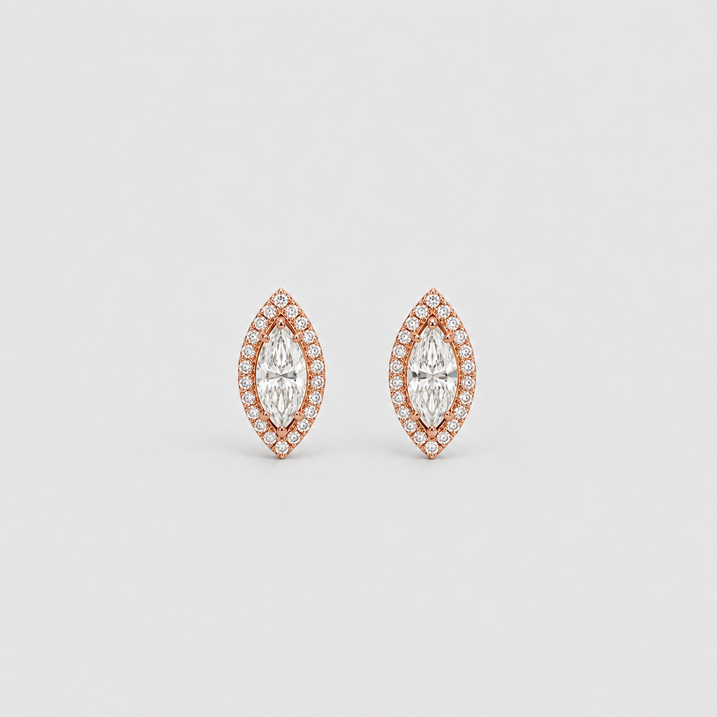 A pair of rose gold stud earrings featuring marquise-shaped clear gemstones surrounded by small pavé-set stones, shown on a light gray background.