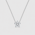 A delicate silver chain necklace with a small snowflake-shaped cluster of clear gemstones on a light gray background.