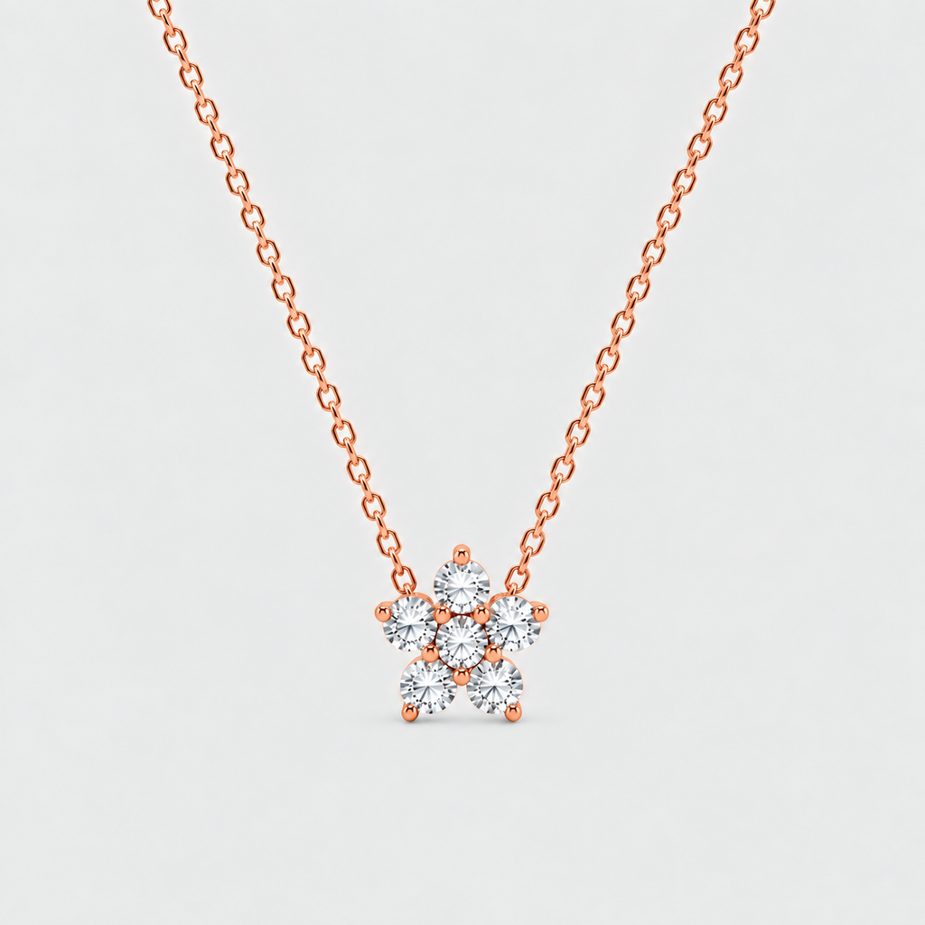A rose gold necklace with a delicate chain and a small flower-shaped pendant set with clear round-cut gemstones, shown against a light gray background.