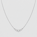 A delicate silver chain necklace featuring a small V-shaped cluster of clear round-cut gemstones at the center, set against a light gray background.