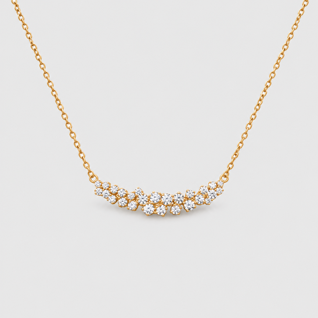 Gold chain necklace featuring a curved cluster of brilliant round diamonds.