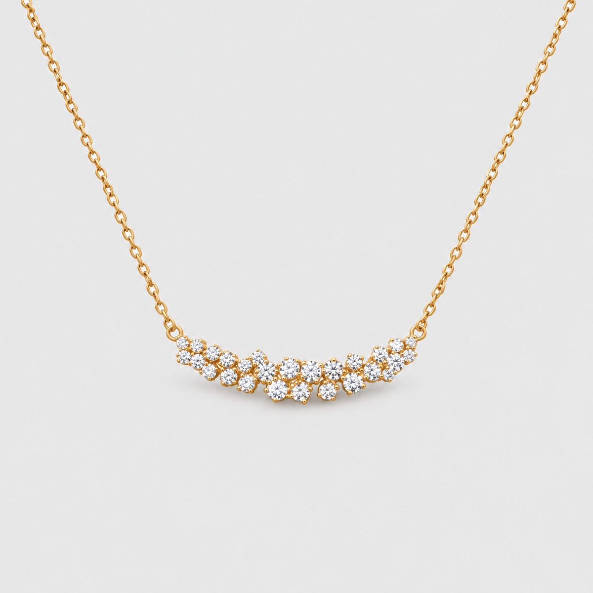 Gold chain necklace featuring a curved cluster of brilliant round diamonds.