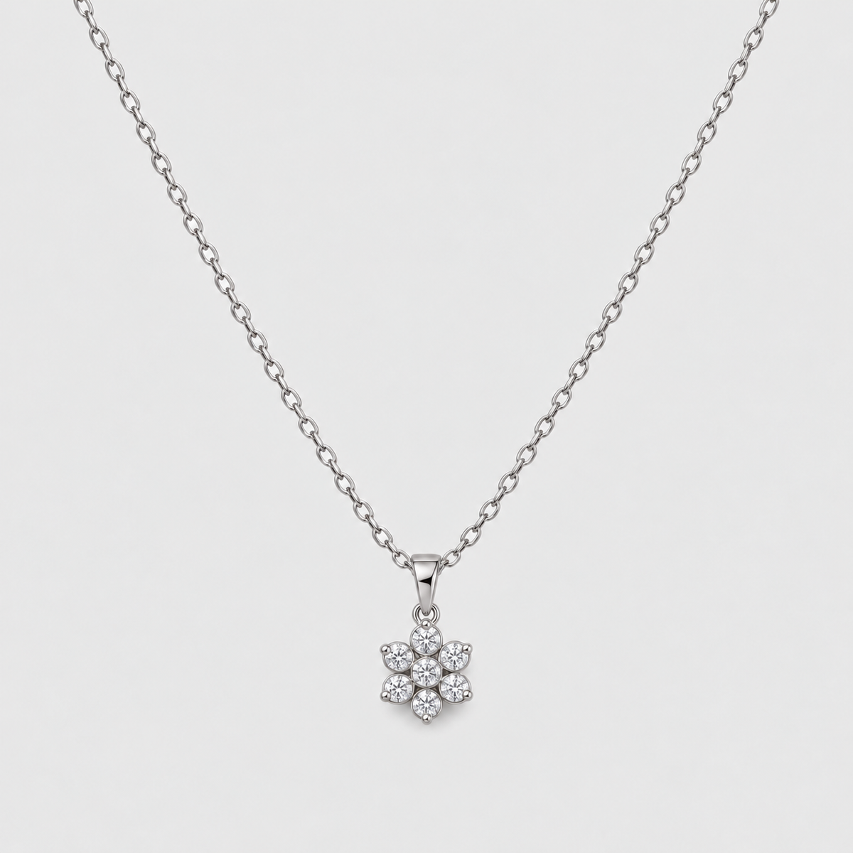 Cluster diamond pendant necklace with a delicate white gold chain.