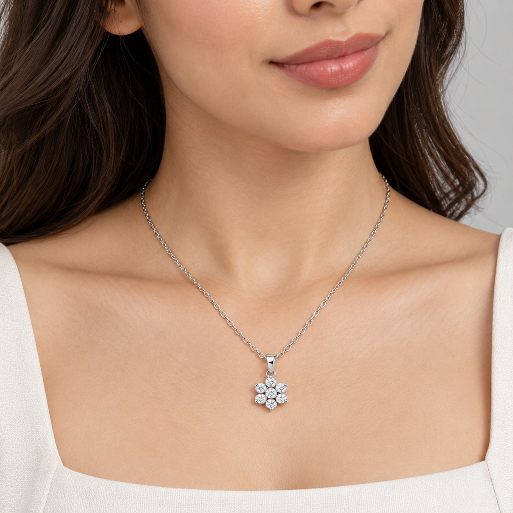 A woman wearing a white gold diamond cluster flower pendant necklace.