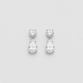 A pair of silver drop earrings featuring a round-cut clear gemstone at the top and a pear-cut clear gemstone below, set against a light gray background.