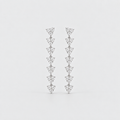A pair of silver-toned drop earrings featuring a vertical stack of small triangular pavé diamond clusters, set against a plain light gray background.