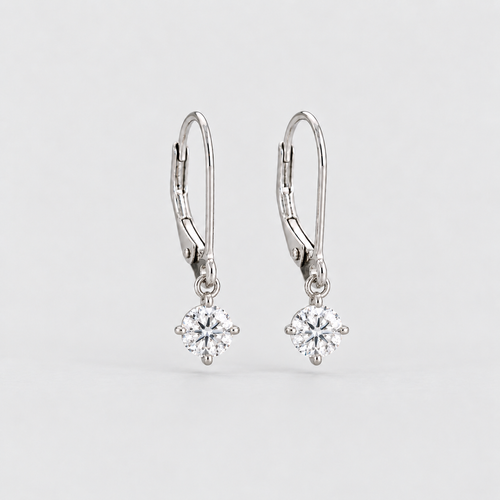 A pair of silver leverback earrings, each featuring a round-cut clear gemstone in a prong setting, shown against a light gray background.