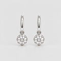 A pair of silver hoop earrings with round-cut clear gemstones in a prong setting, displayed on a light gray background.