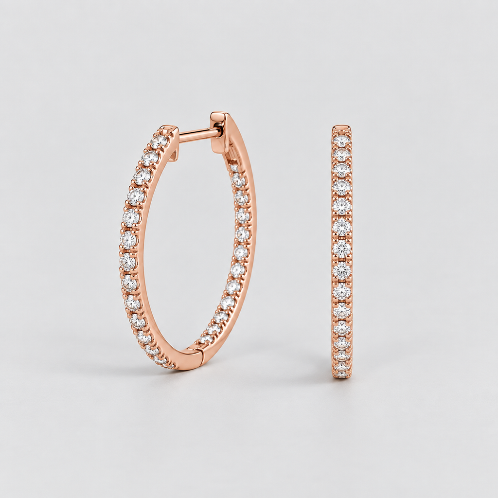 Rose gold hoop earrings with pavé-set clear stones, shown in a clean studio shot against a light gray background.