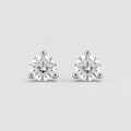A pair of round-cut solitaire stud earrings in a silver-toned setting, displayed on a clean light gray background.
