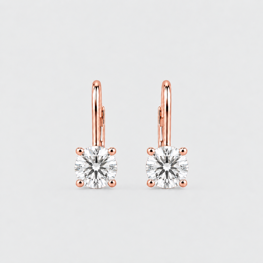 A pair of rose gold leverback earrings with square-cut clear gemstones in four-prong settings, shown on a light gray background.