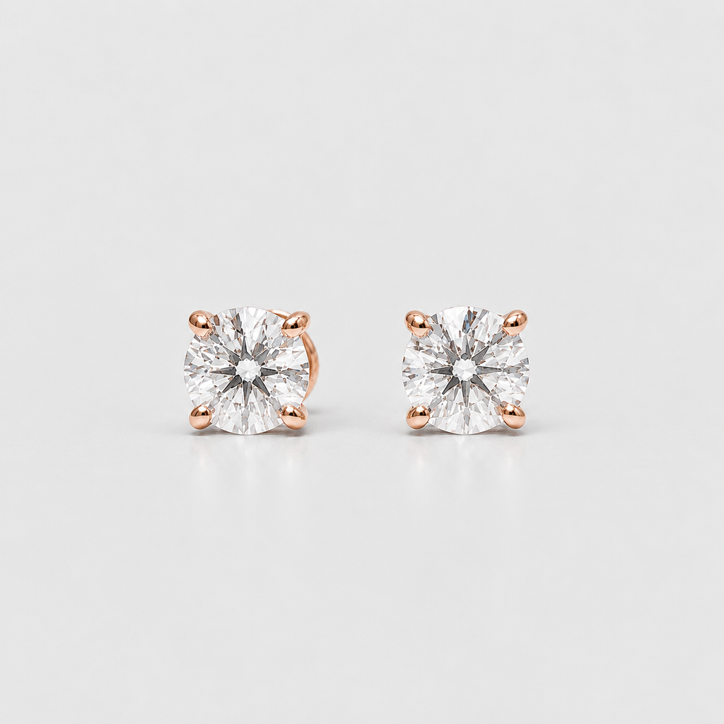 A pair of square-cut diamond stud earrings in four-prong rose gold settings, displayed on a clean light gray background.